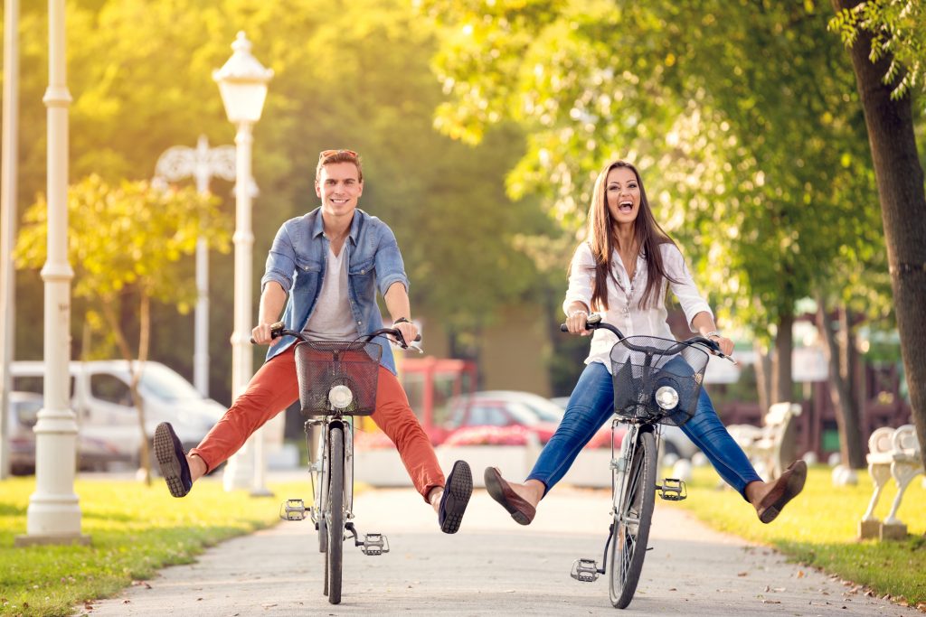 Two riders enjoying a bike rental on a sunny path
