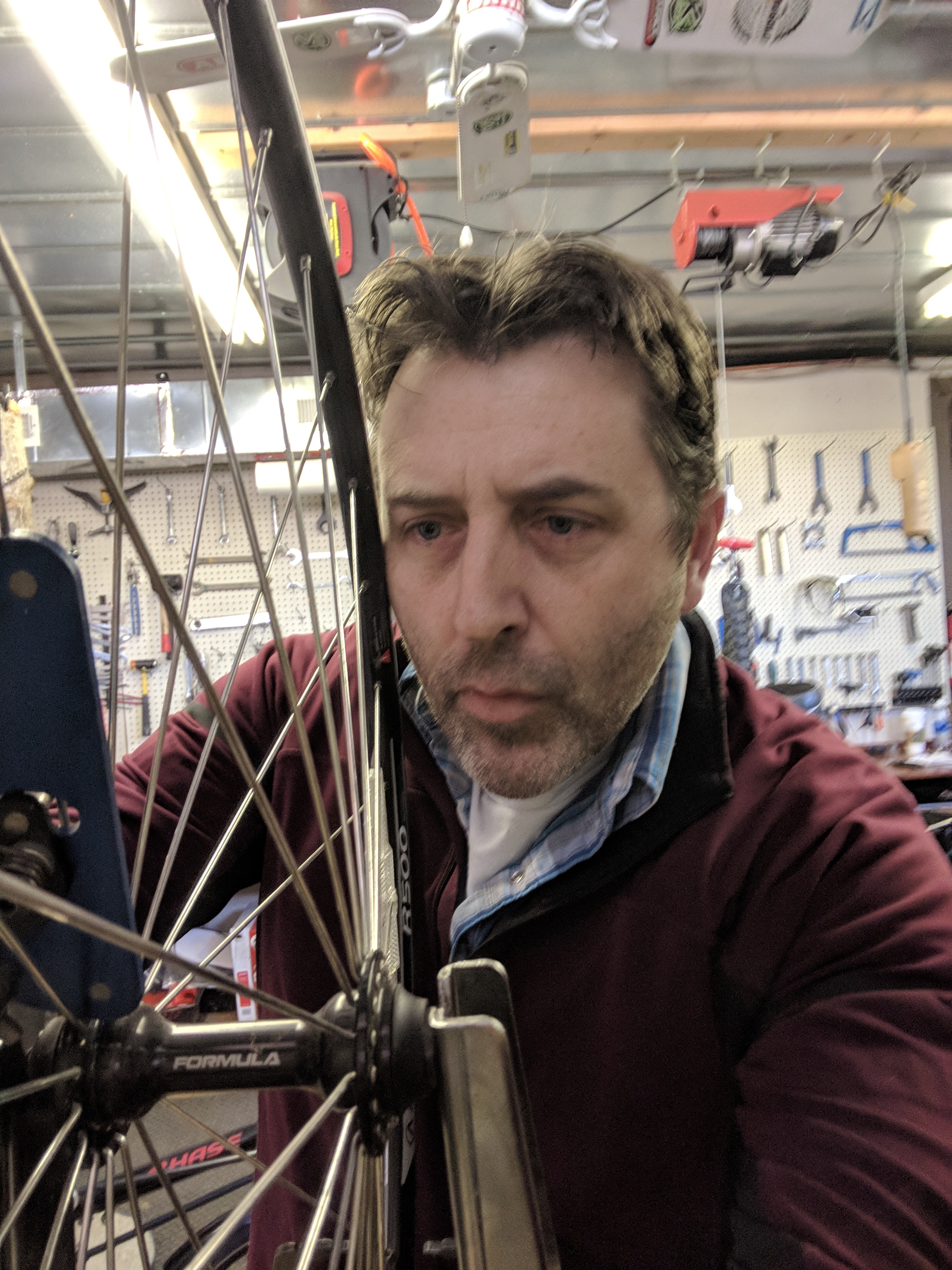 Rob working on a bike wheel in the shop